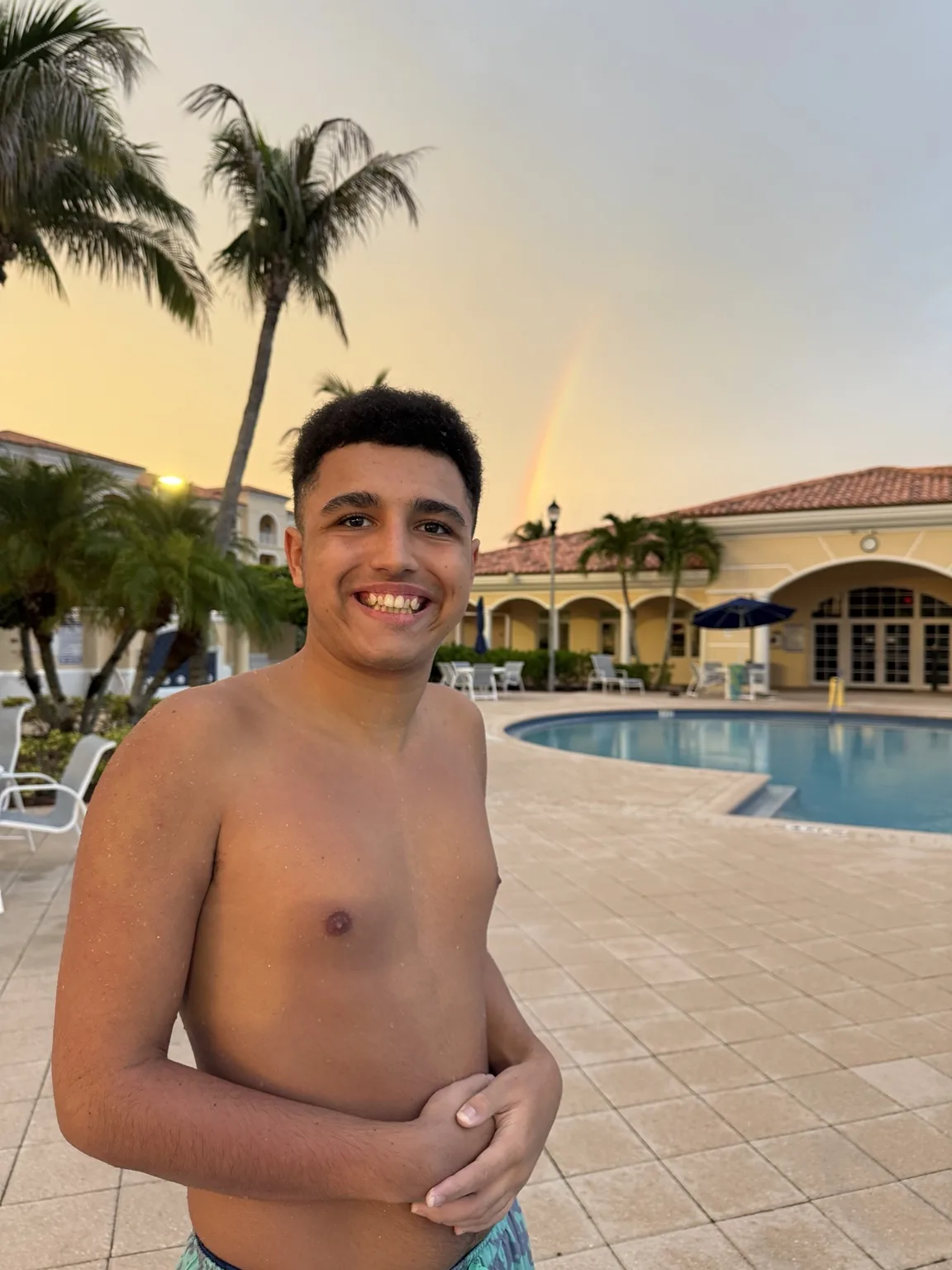 Evan with a rainbow behind him
